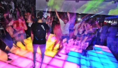 People on a lit-up dance floor.