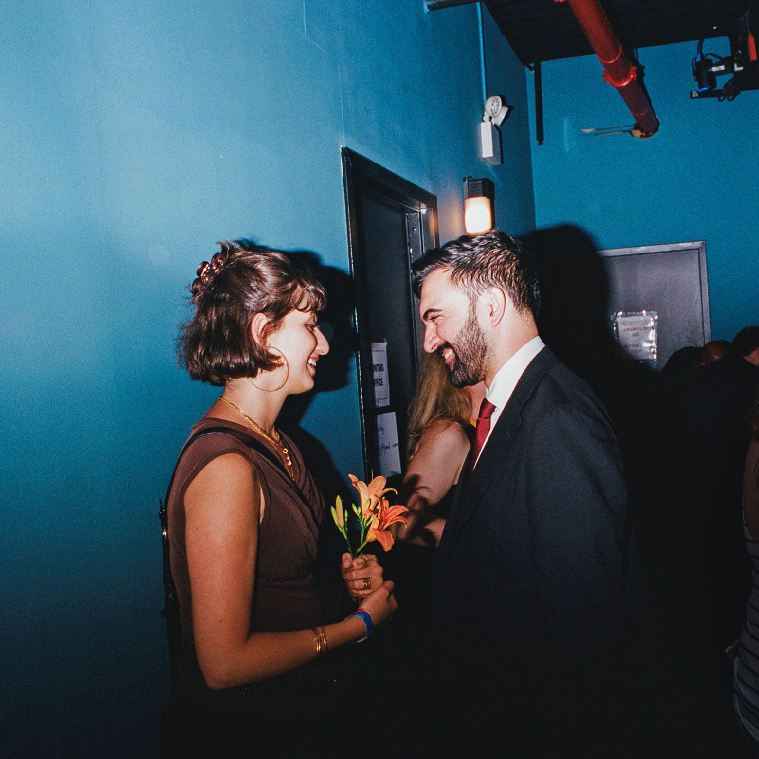 Mamdani hands a lily to his wife.