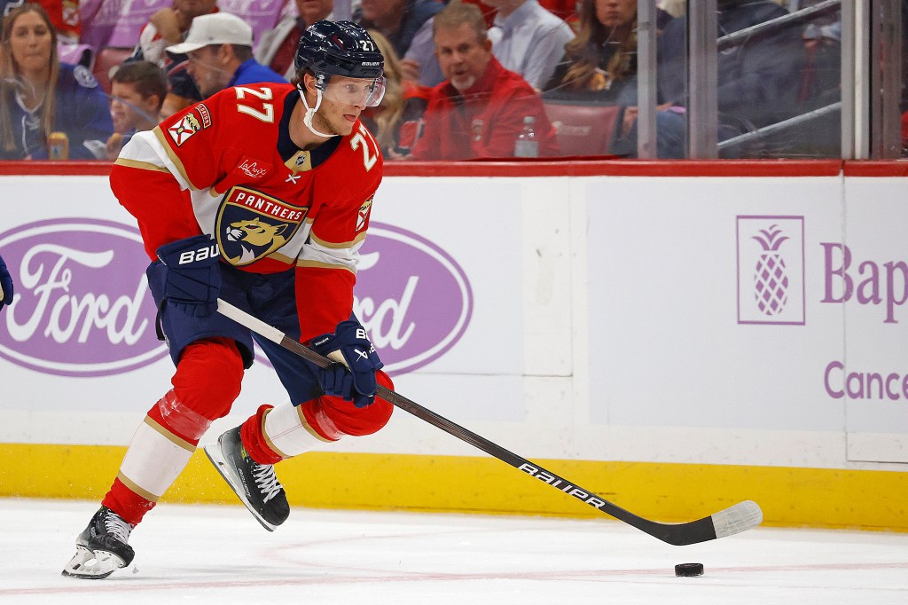 Eetu Luostarinen #27 of the Florida Panthers skates with the puck against the Tampa Bay Lightning at the Amerant Bank Arena on November 15, 2025 in Sunrise, Florida. 