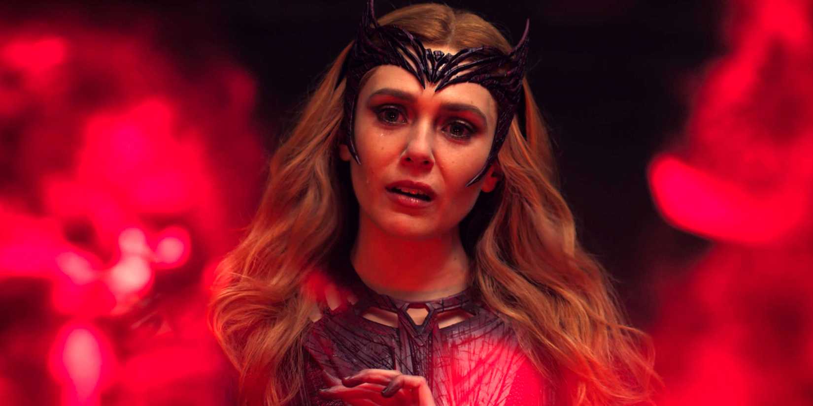 Elizabeth Olsen as Wanda:Scarlet Witch looking sad at alternate universe orbs in Doctor Strange in the Multiverse of Madness