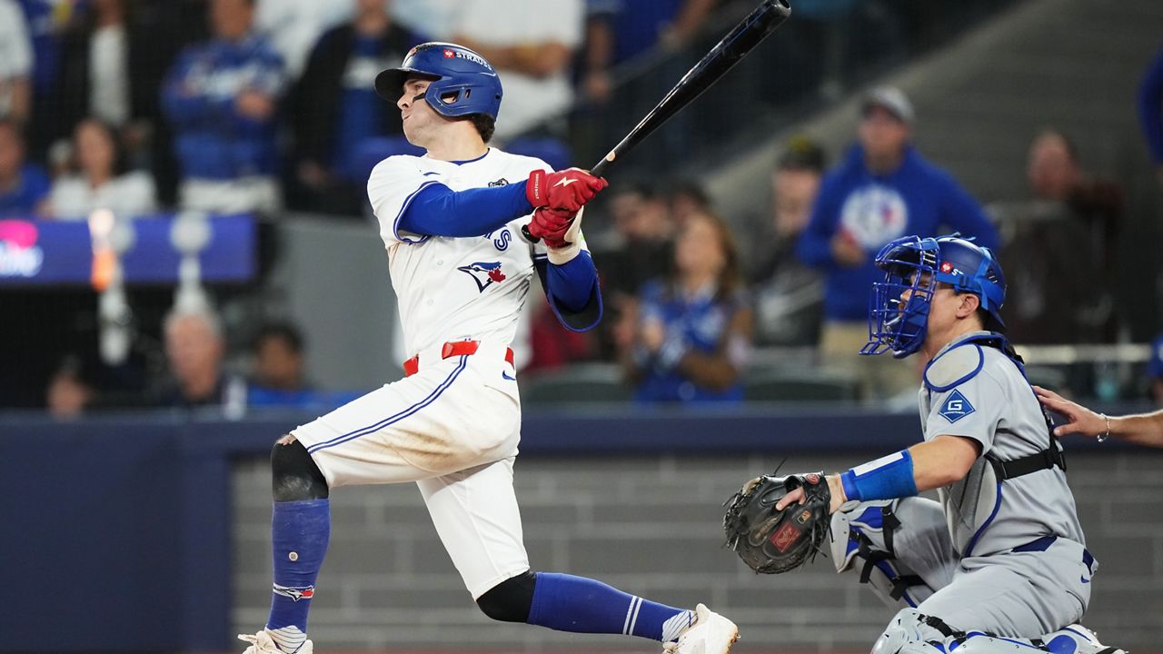 Toronto Blue Jays' Ernie Clement hits a double against the Los Angeles Dodgers during the eighth inning in Game 7 of baseball's World Series in Toronto on Saturday, Nov. 1, 2025. (Nathan Denette/The Canadian Press via AP)