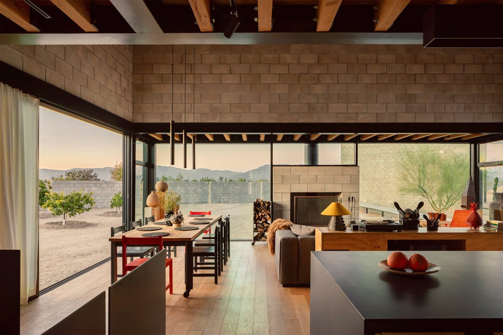 Open-concept kitchen and dining area with modern design elements and outdoor view.