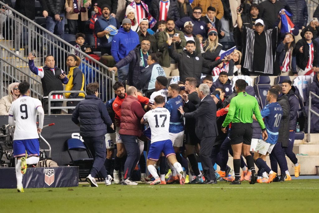 A fight breaking out between the United States and Paraguay soccer teams during a game.
