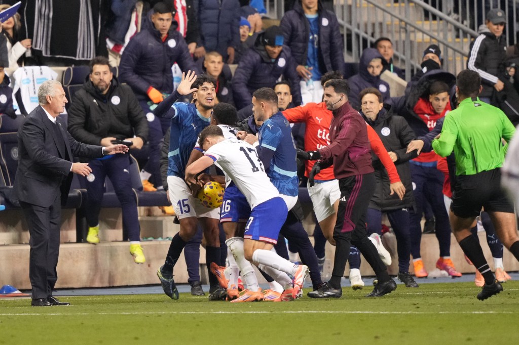 A fight between Paraguay and USA players during a soccer game.