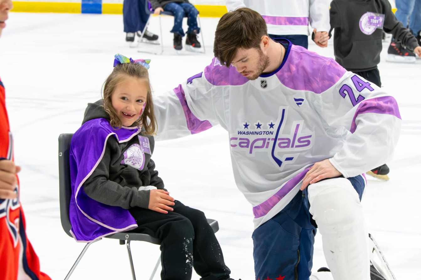 Connor McMichael and Eliza on the ice during the Hockey Fights Cancer skate.
