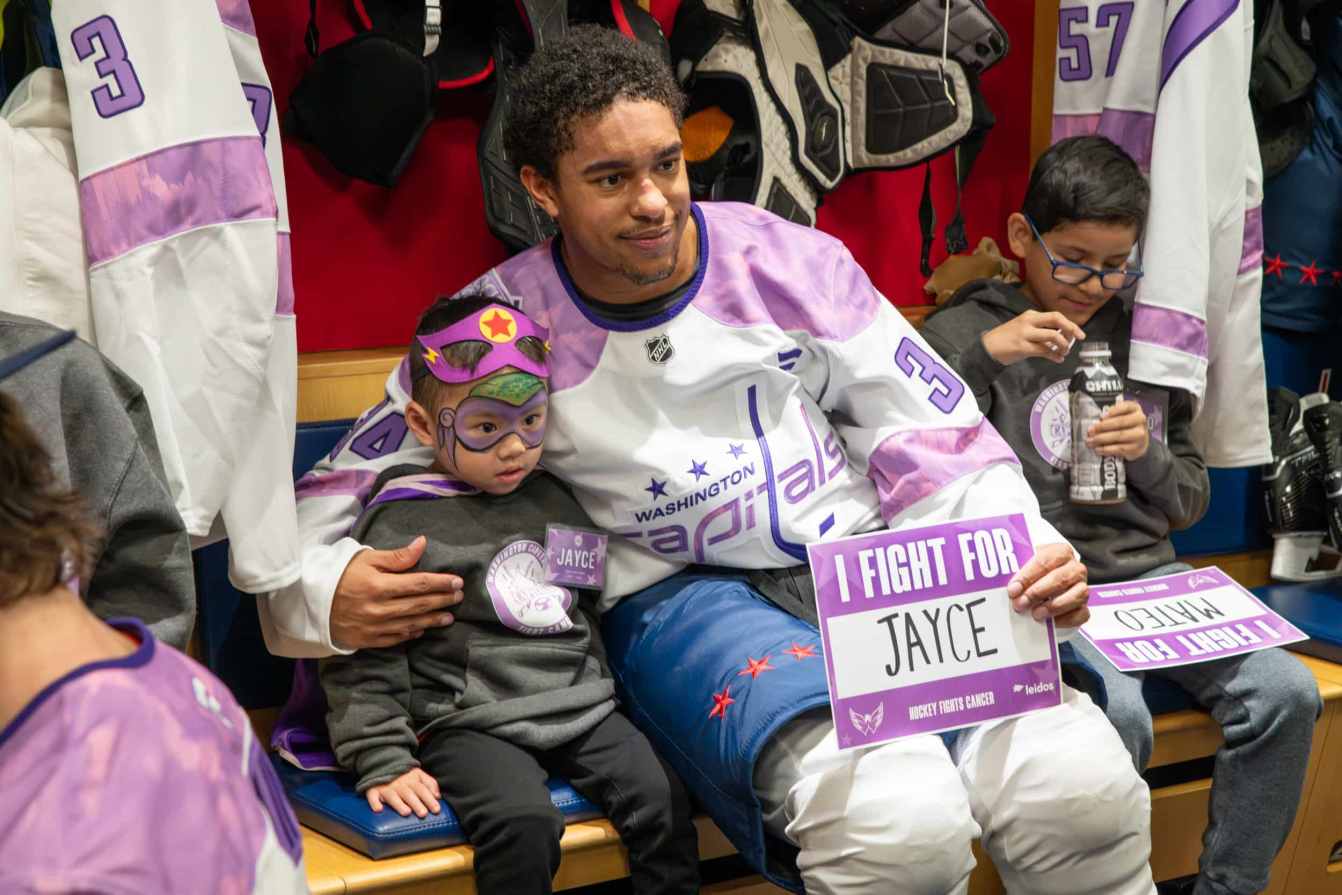 Justin Sourdif and Jayce in the locker room before the Hockey Fights Cancer skate.