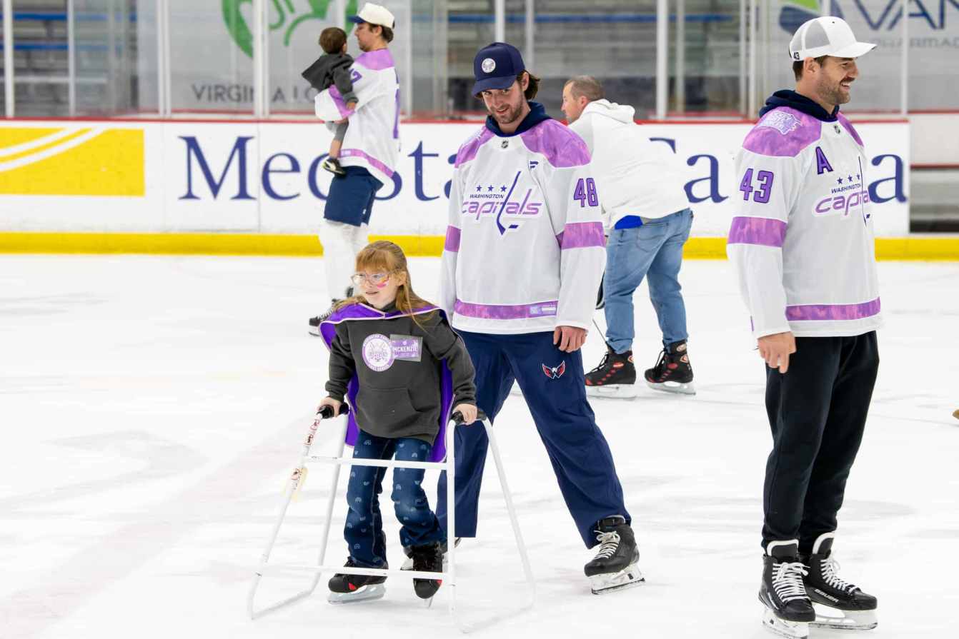 Logan Thompson and McKenzie on the ice during the Hockey Fights Cancer skate.