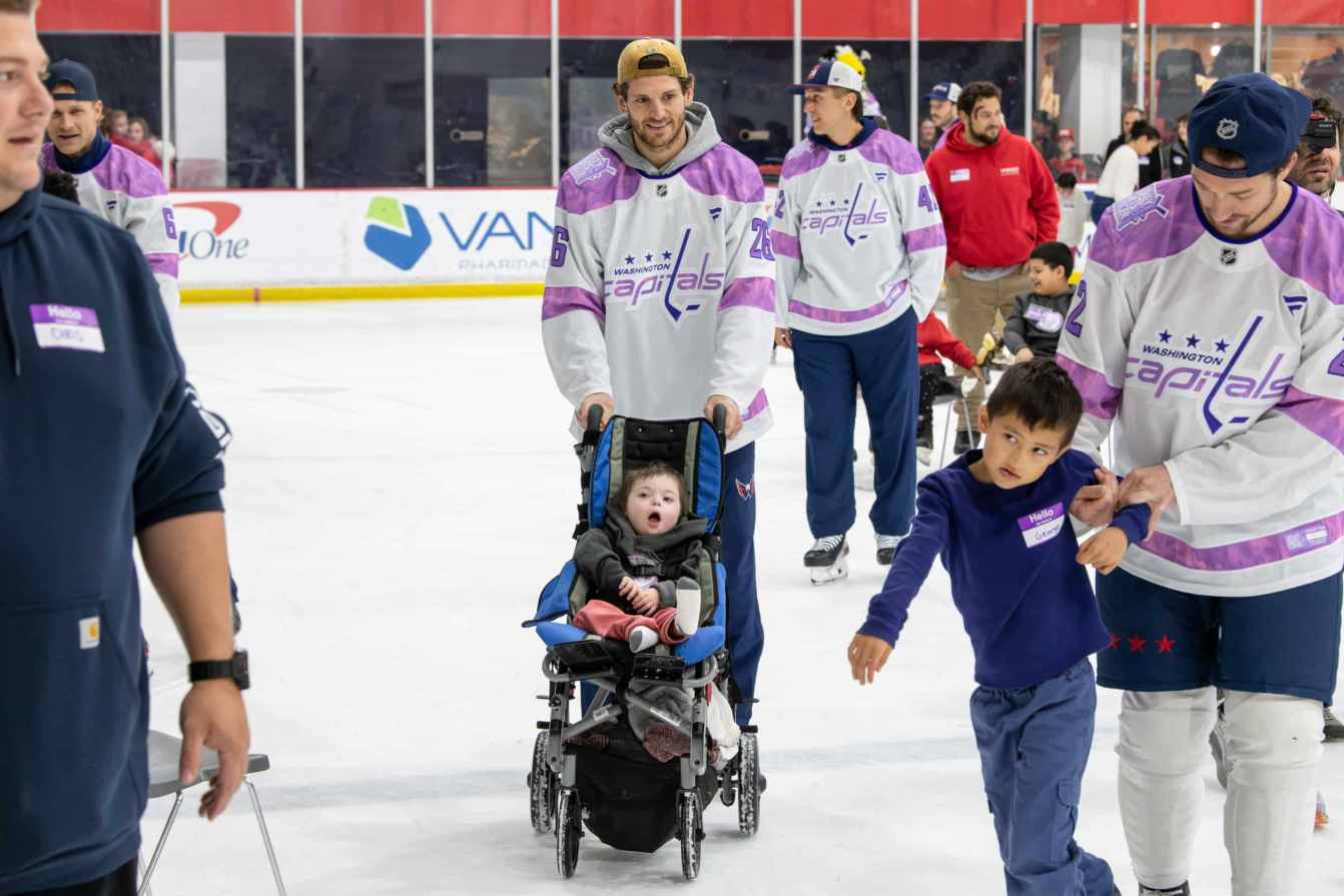 Nic Dowd and a child on the ice during the Hockey Fights Cancer skate.