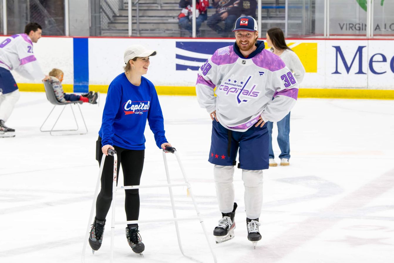 Rasmus Sandin and Shelby on the ice during the Hockey Fights Cancer skate.