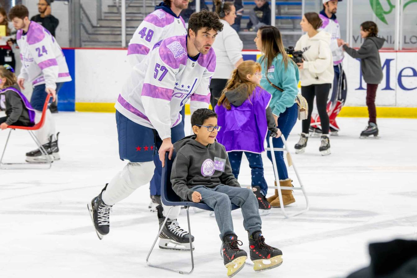Trevor van Riemsdyk and Mateo on the ice during the Hockey Fights Cancer skate.