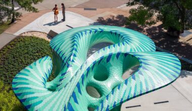 an aerial view of a contemporary, teal-colored pavilion designed by Marc Fornes/THEVERYMANY in a public square in Knoxville, Tennessee