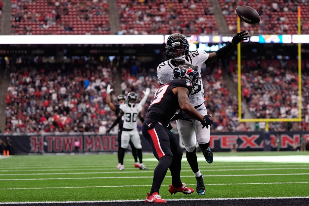 Jacksonville Jaguars cornerback Jarrian Jones (22) gets a pass interference against Houston Texans wide receiver Christian Kirk (13).