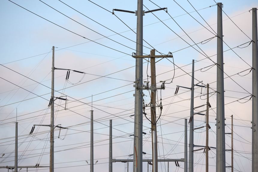 Transmission lines and electricity infrastructure adjacent to a construction site for an Amazon Web Services data center in Hilliard, Ohio, on March 23, 2024.