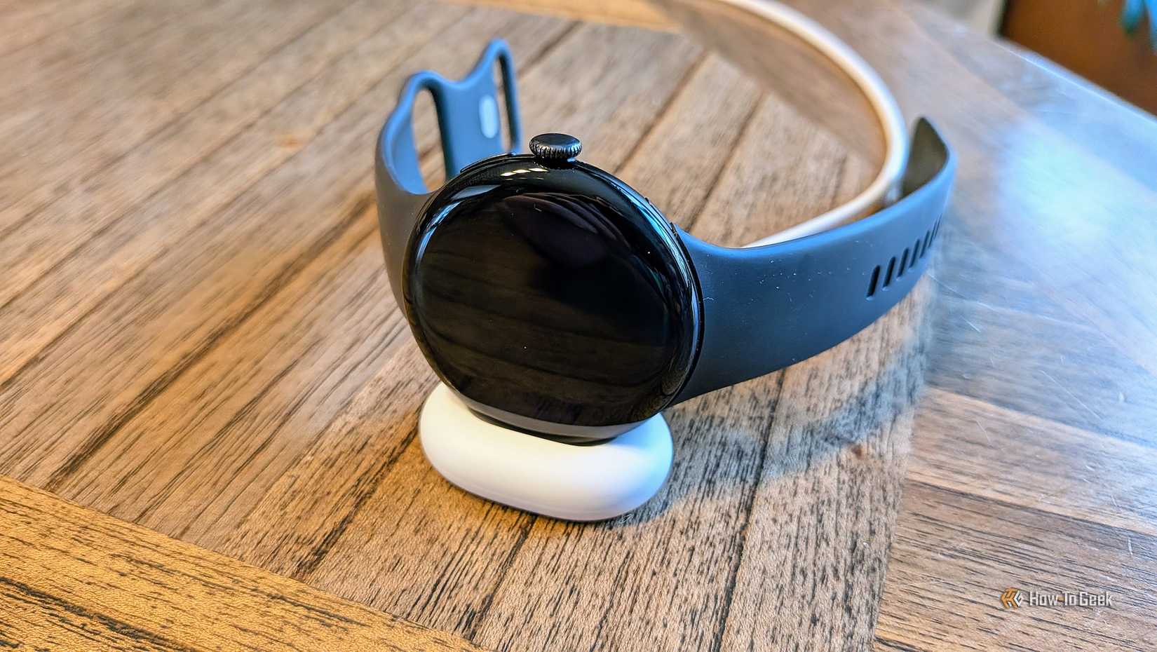 Google Pixel Watch 4 on its charger.