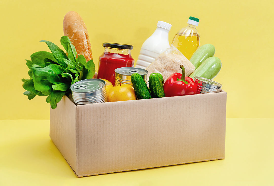A box full of groceries and produce.