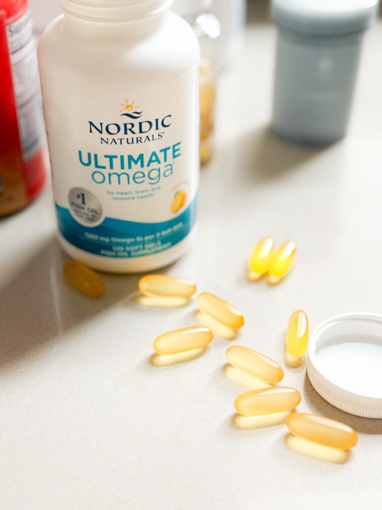 Bottle of Nordic Naturals Fish Oil supplements on a counter.