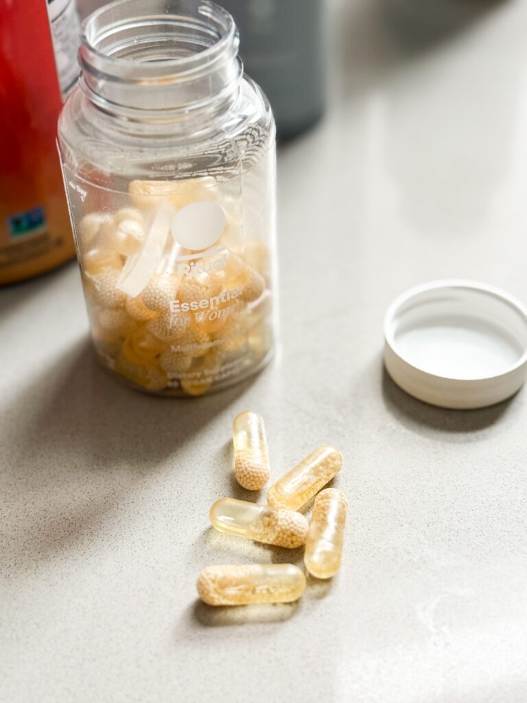 Ritual multivitamin bottle with bright yellow capsules.