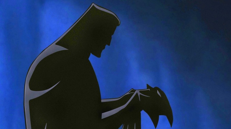 Batman: Mask of the Phantasm - Bruce Wayne, in shadow, putting on the Batman mask for the first time