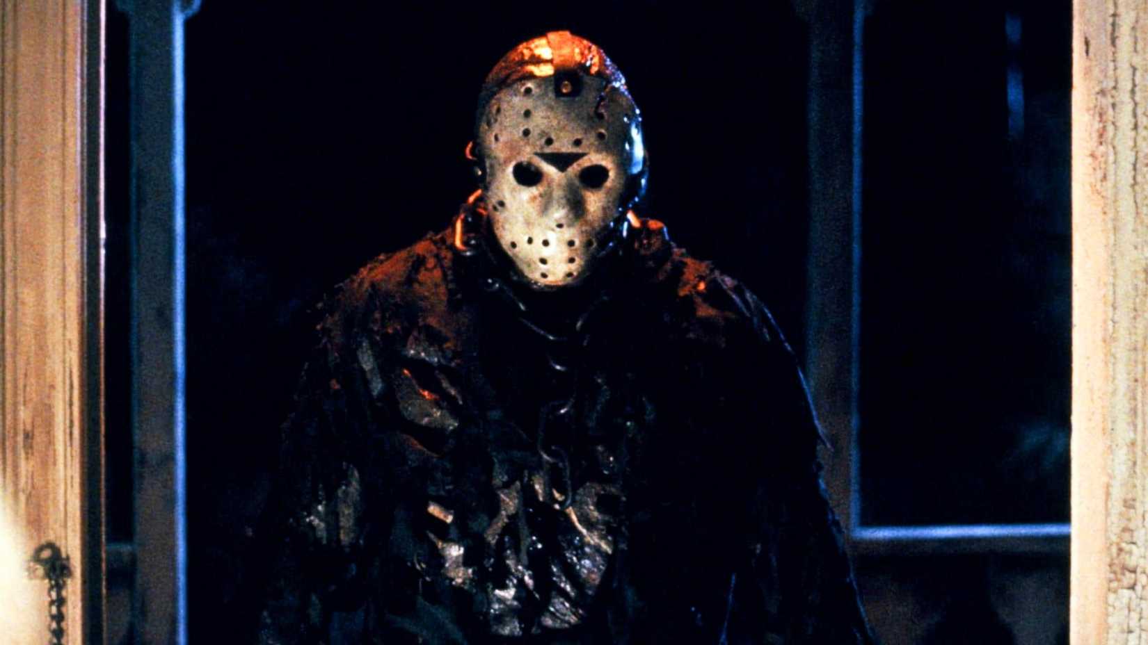 Jason Voorhees looms in a darkened doorway in Friday the 13th: The New Blood