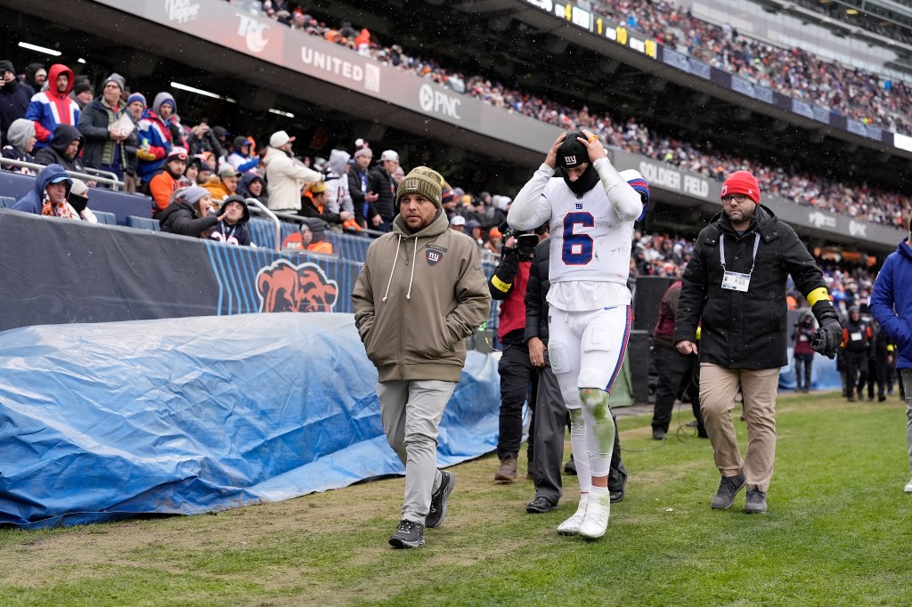 Jaxson Dart of the New York Giants walks off the field after an injury during the fourth quarter against the Chicago Bears.