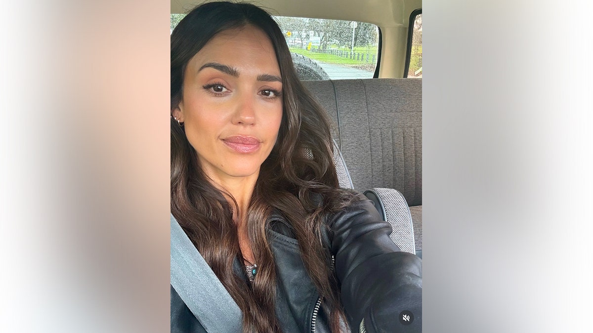 Jessica Alba beaming in a car selfie
