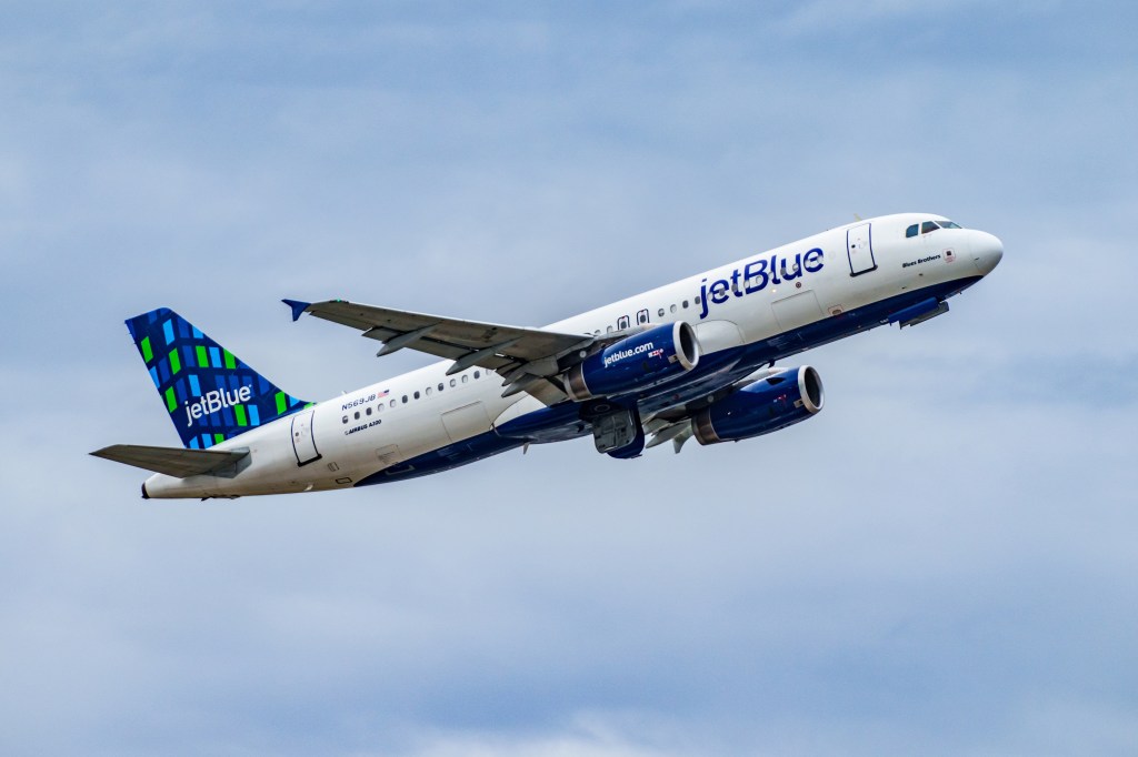 JetBlue plane in clear blue sky