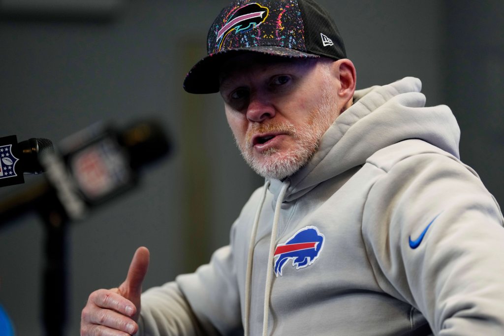 A man in a Bills cap and sweatshirt at a press conference.