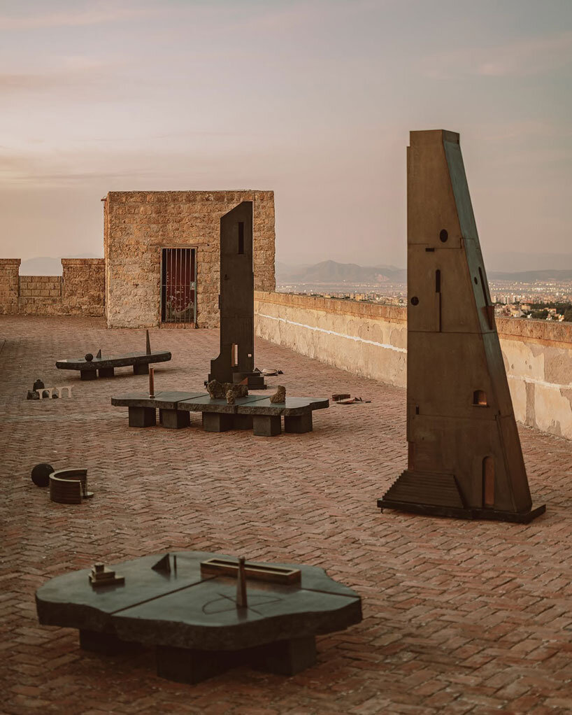 totemic sculptures compose volcanic stone landscape for site-specific installation in naples