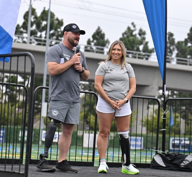 Danielle McLaughlin, an amputee and director of patient access and clinical operations for Moores Cancer Center in La Jolla, receives a new running prosthetic from the Challenged Athletes Foundation on Oct. 25. (Challenged Athletes Foundation)
