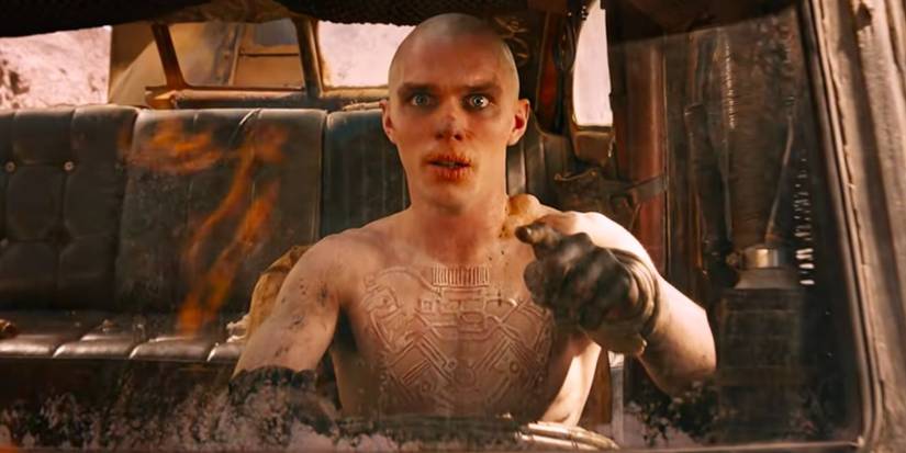 A shirtless Nicholas Hoult as Nux, driving the War rig from the 2015 movie Mad Max: Fury Road