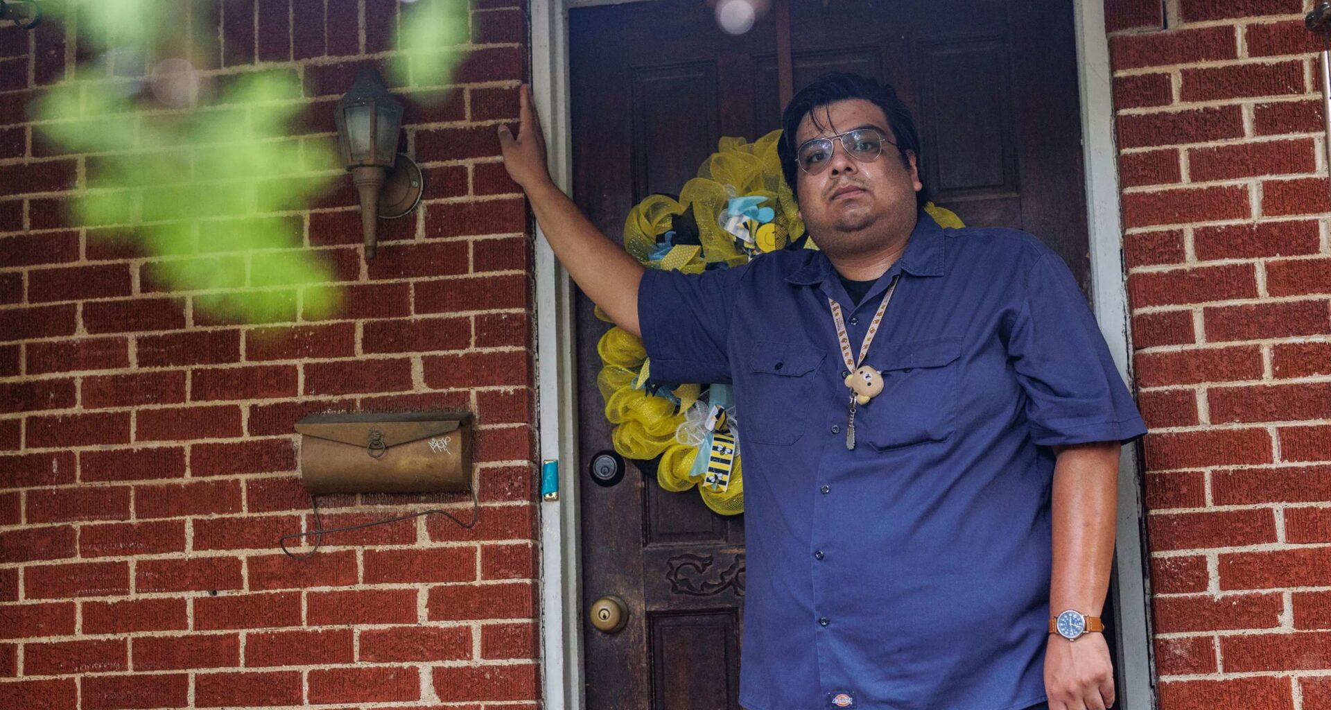Cristo Mendoza stands in the doorway of his family's home in Southeast Dallas.