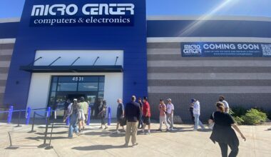 People lined up outside the entrance of a Micro Center store.
