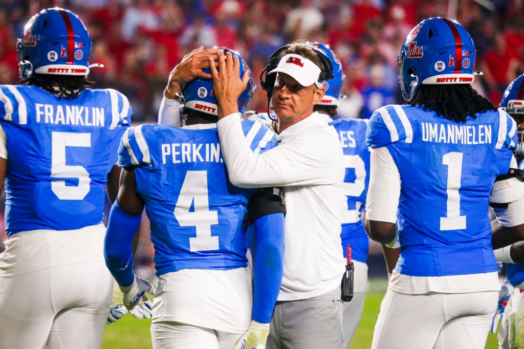 Mississippi Rebels head coach Lane Kiffin embraces linebacker Suntarine Perkins (4) during the second half against the Florida Gators.