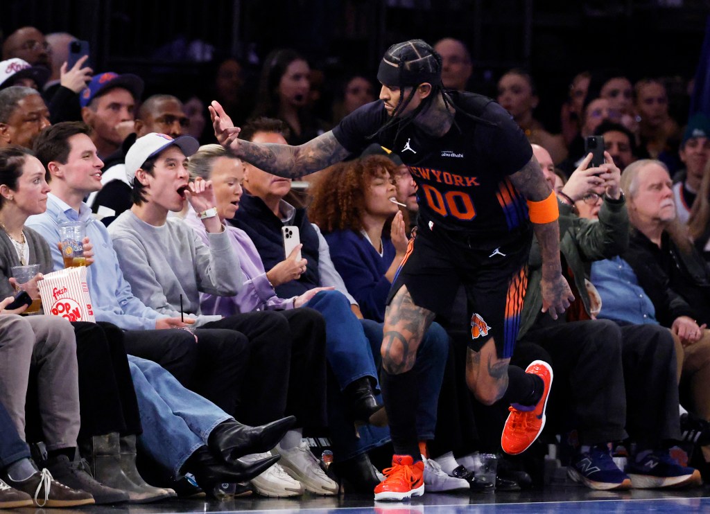 New York Knicks guard Jordan Clarkson interacts with fans during a game.