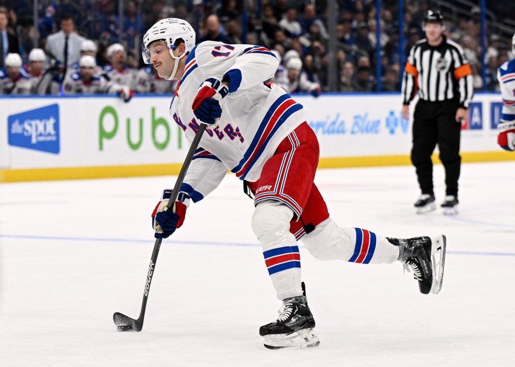 Will Borgen of the New York Rangers skating with a hockey stick on ice.