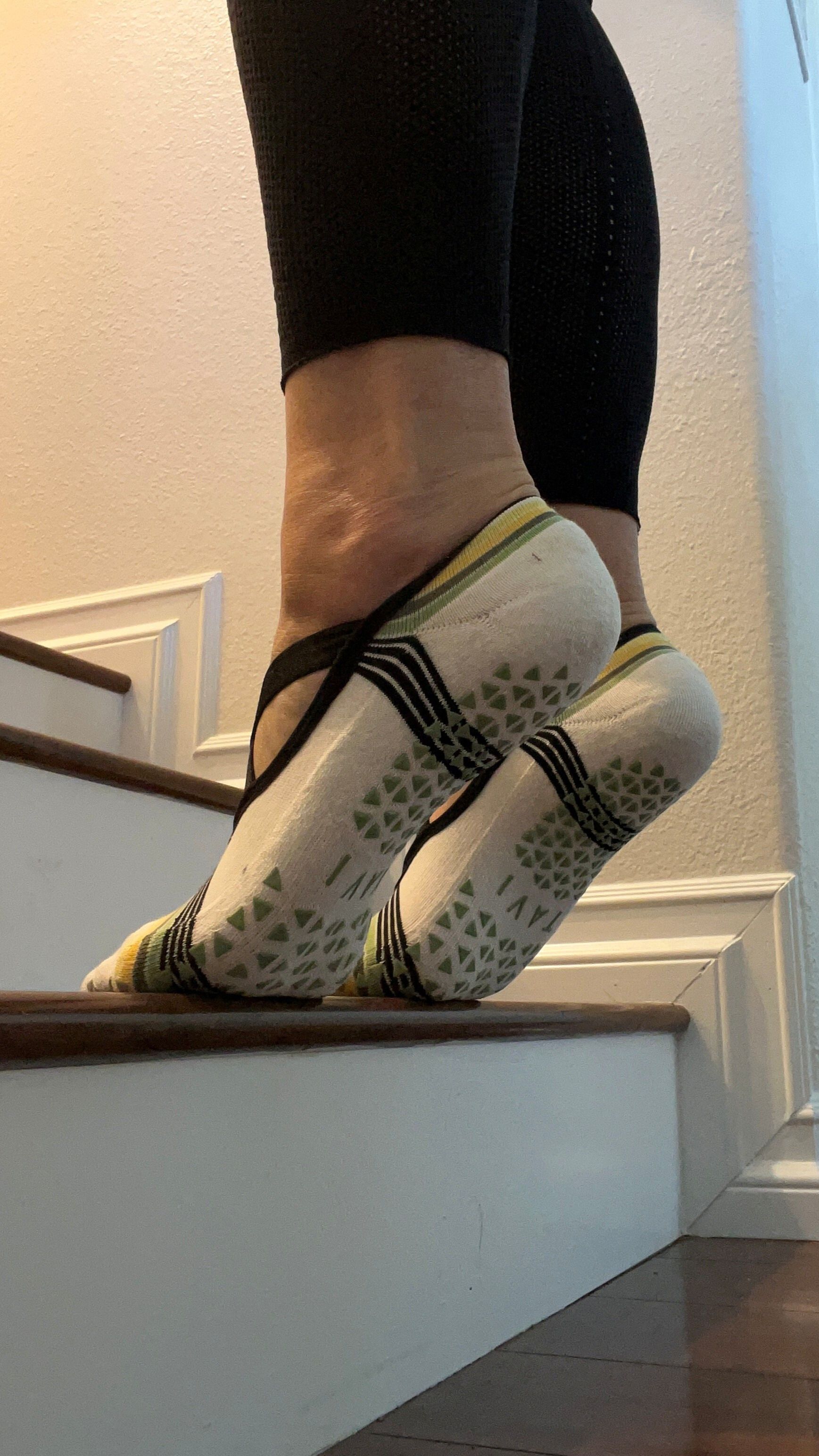 Balls of feet on a step with heels raised