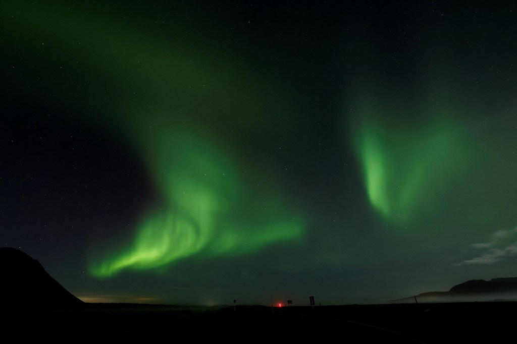 Northern Lights, also called aurora borealis, illuminate the night sky near the town of Thorlakshofn.