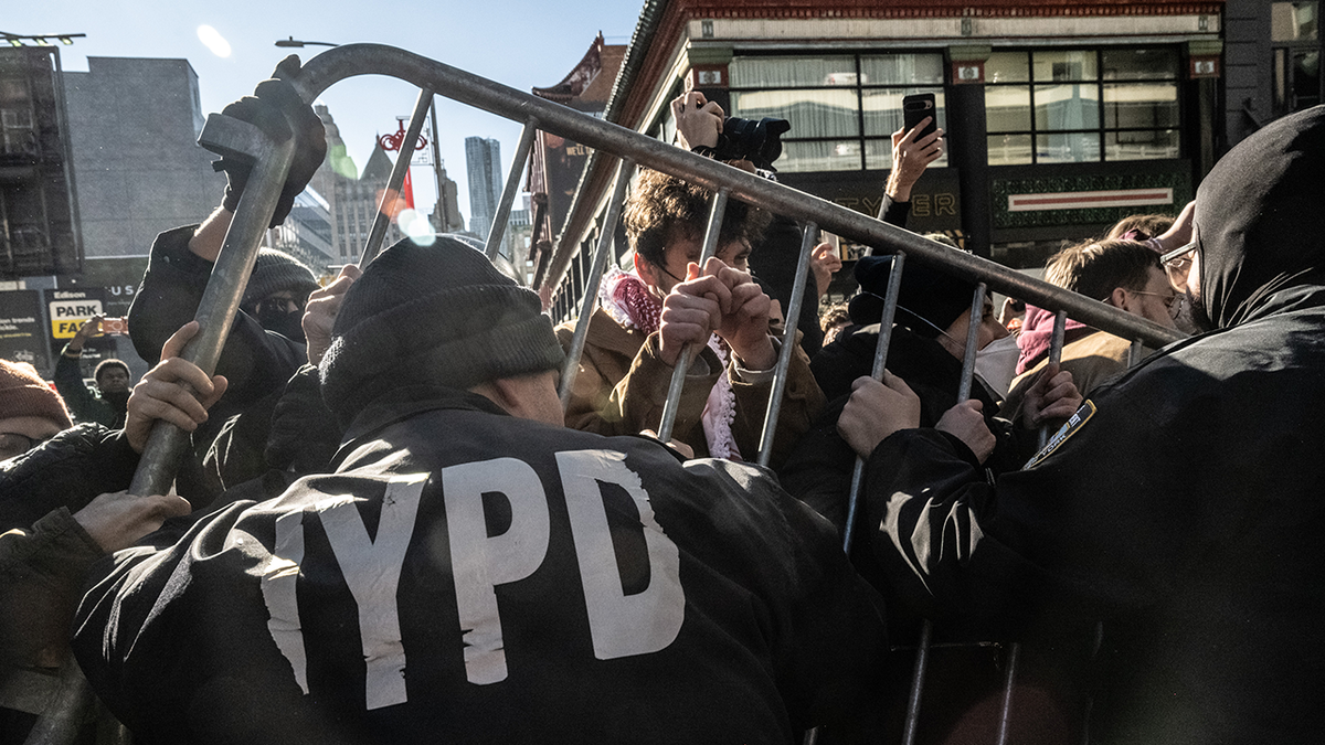 Protesters in New York City battle NYPD officers with a barricade on Saturday, Nov. 29, 2025.