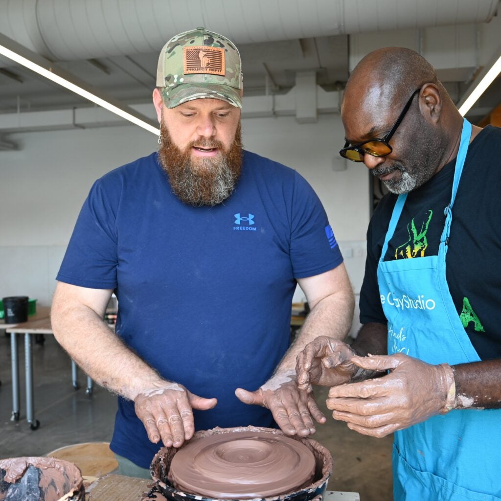 Bradford Davis and Keith Ockimey at a pottery wheel