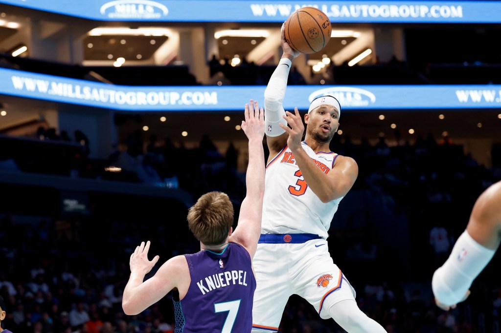 Josh Hart (3) passes over Charlotte Hornets guard Kon Knueppel during the second half of an Emirates NBA Cup basketball game in Charlotte.