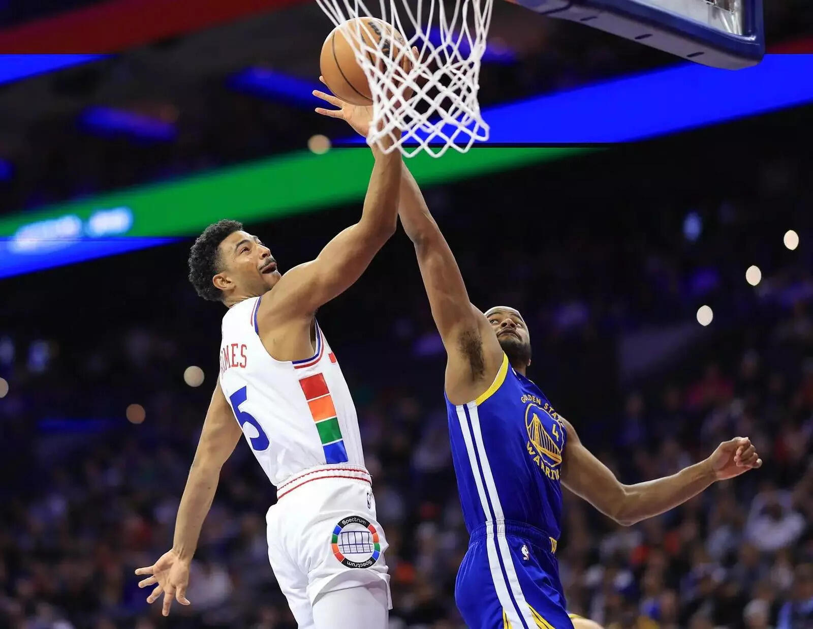 Philadelphia 76ers guard Quentin Grimes (5) scores past Golden State Warriors guard Moses Moody (4) during the first quarter at Wells Fargo Center