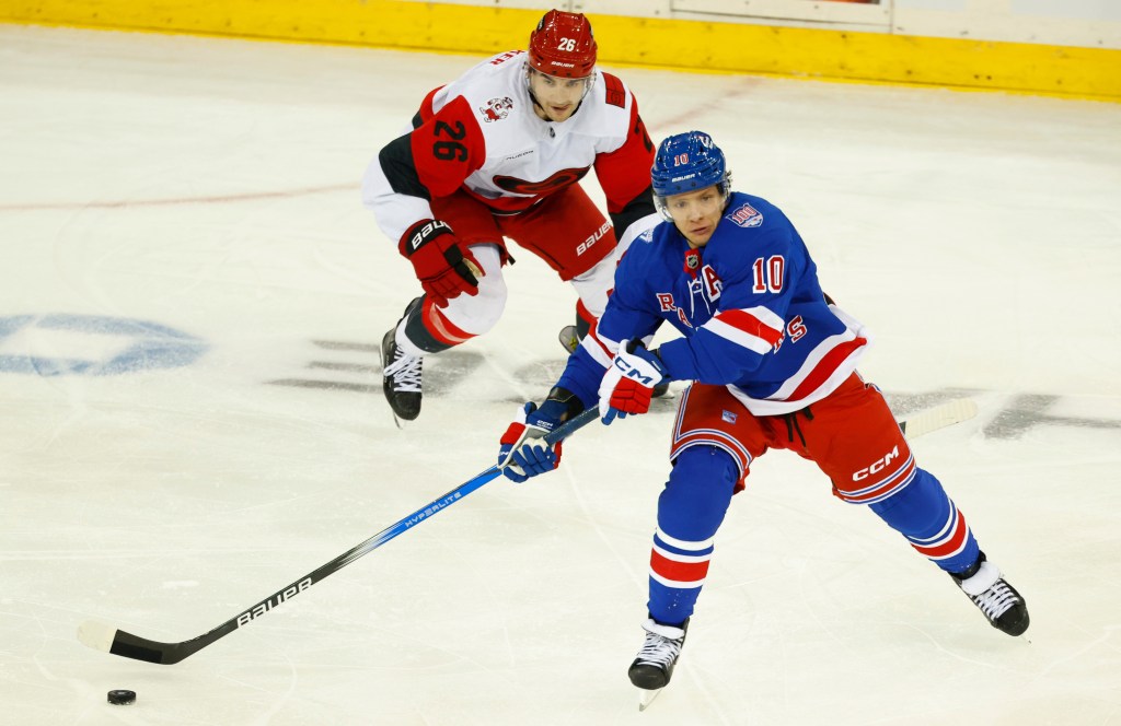 Rangers left wing Artemi Panarin (10) plays the puck against Carolina Hurricanes defenseman Sean Walker