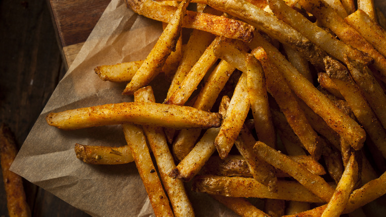 Cajun-seasoned fries on parchment paper