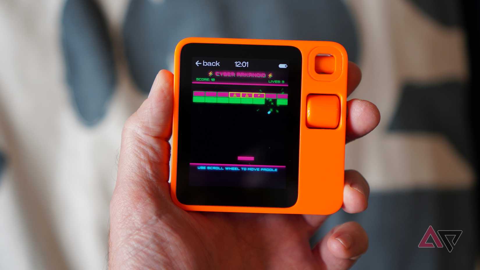 A person playing a game on the Rabbit R1