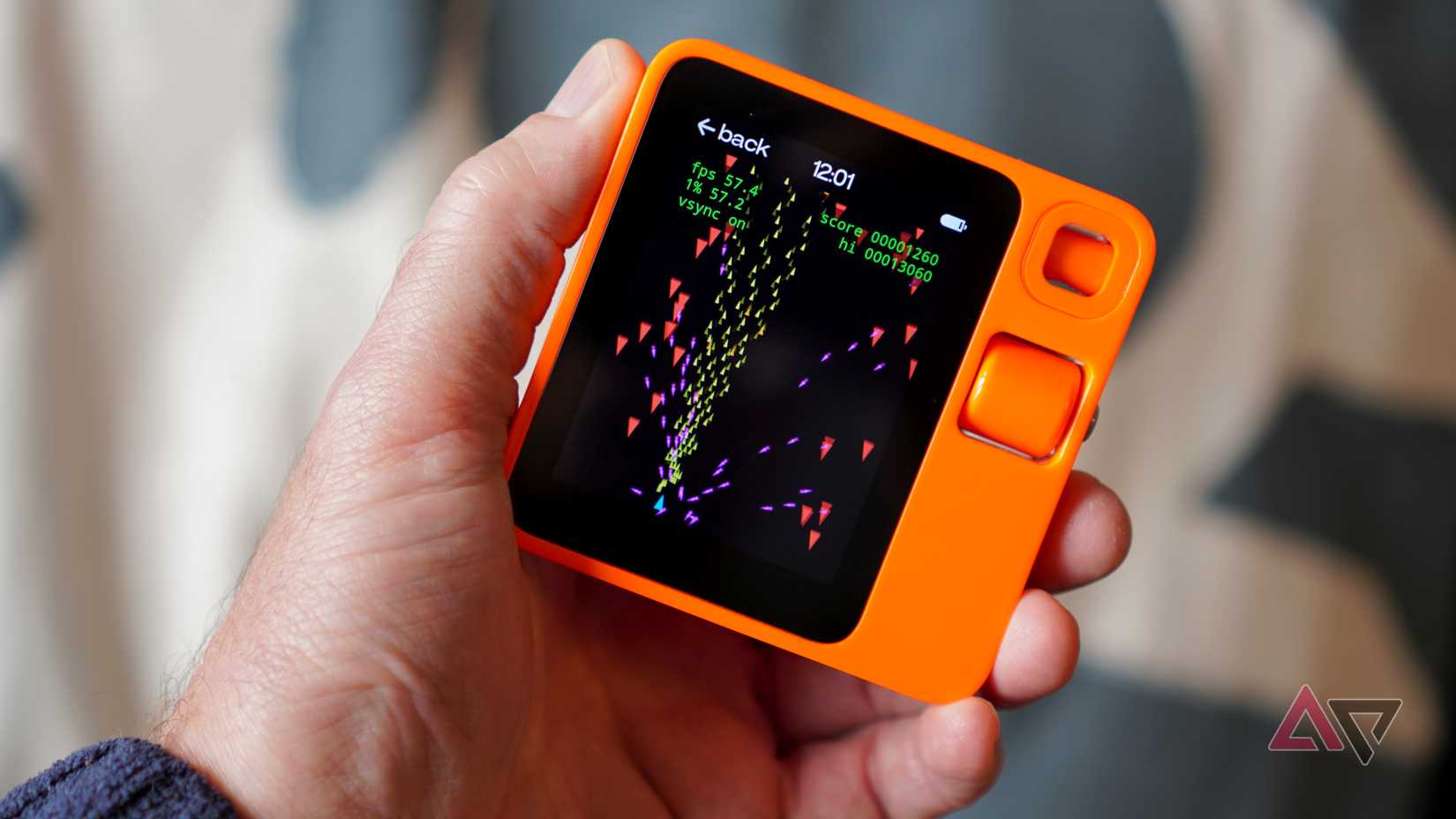 A person playing a game on the Rabbit R1