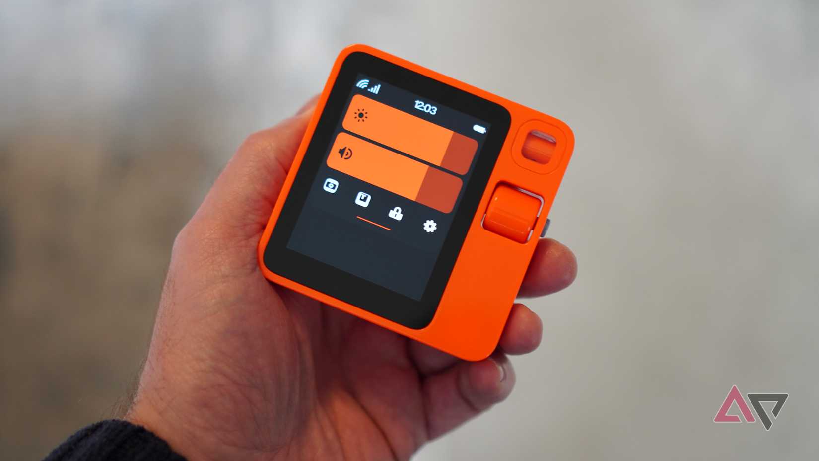 A person holding the Rabbit R1