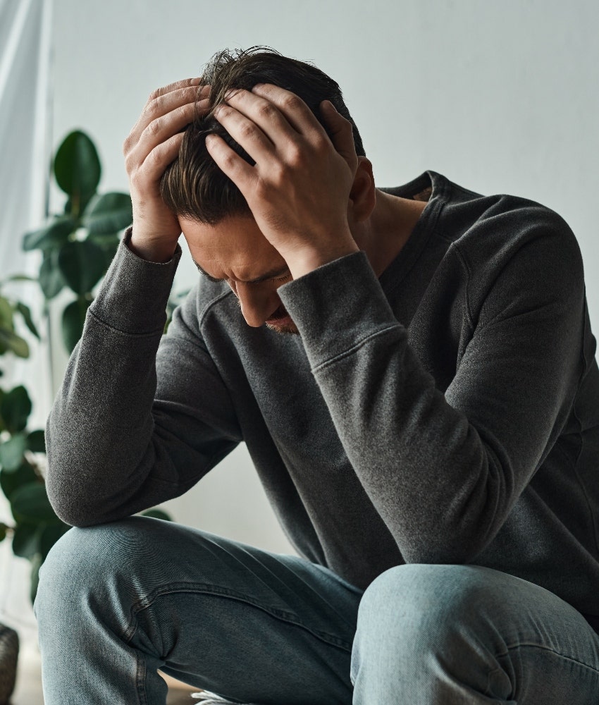 man feeling depressed about his tattoos