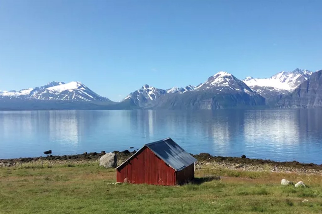Red farmhouse on Scandinavian lake