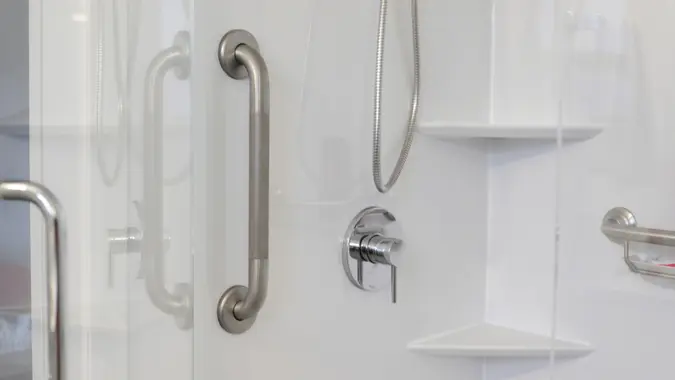 A metal wall bar can help a person reduce falls and maintain balance when entering or leaving a shower stall.