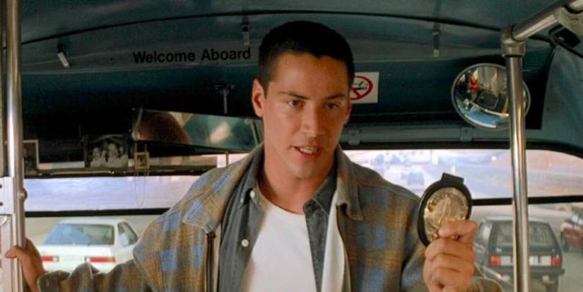 Keanu Reeves as Jack Traven holding his badge on the bus in 1994 Speed